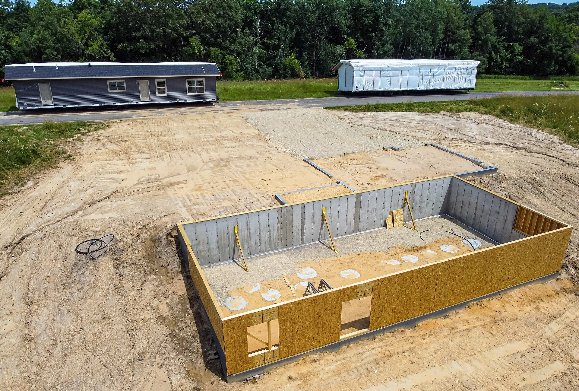 Modular home prefab sections to be placed on the foundation. Architect versus design build versus prefab: small home design firms compared